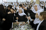 Members of the Israeli Druze minority mourn around the body of Tiran Fero, 17, during his funeral in Daliyat al-Carmel, Israel, Thursday, Nov. 24, 2022. Fero's body, which was taken by Palestinian militants from a West Bank hospital where he was seeking treatment after a car accident, was returned to his family on Thursday. (AP Photo/Mahmoud Illean)