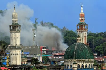 Smoke billows are seen as government troops continue their assault against insurgents from the Maute group, who have taken over parts of Marawi city, Philippines June 22, 2017. REUTERS/Romeo Ranoco