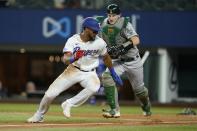 Texas Rangers' Leody Taveras is pursued before being tagged out in a rundown, by Oakland Athletics catcher Sean Murphy during the fifth inning of a baseball game in Arlington, Texas, Tuesday, Aug. 16, 2022. (AP Photo/Tony Gutierrez)