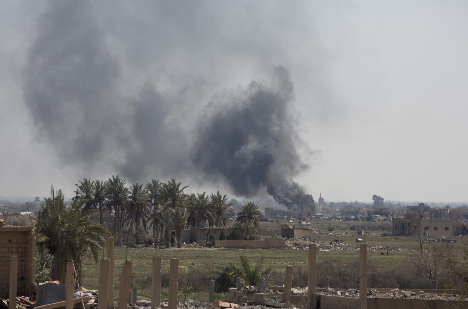 Smoke rises as U.S.-backed Syrian Democratic Forces (SDF) battle Islamic State militants remaining in a pocket of Baghouz, Syria, Monday, March 11, 2019. (AP Photo/Maya Alleruzzo)