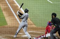 Chicago White Sox's Luis Robert follows through on a three-run double next to Texas Rangers catcher Jose Trevino and umpire Gabe Morales during the fourth inning of a baseball game in Arlington, Texas, Friday, Sept. 17, 2021. (AP Photo/Tony Gutierrez)