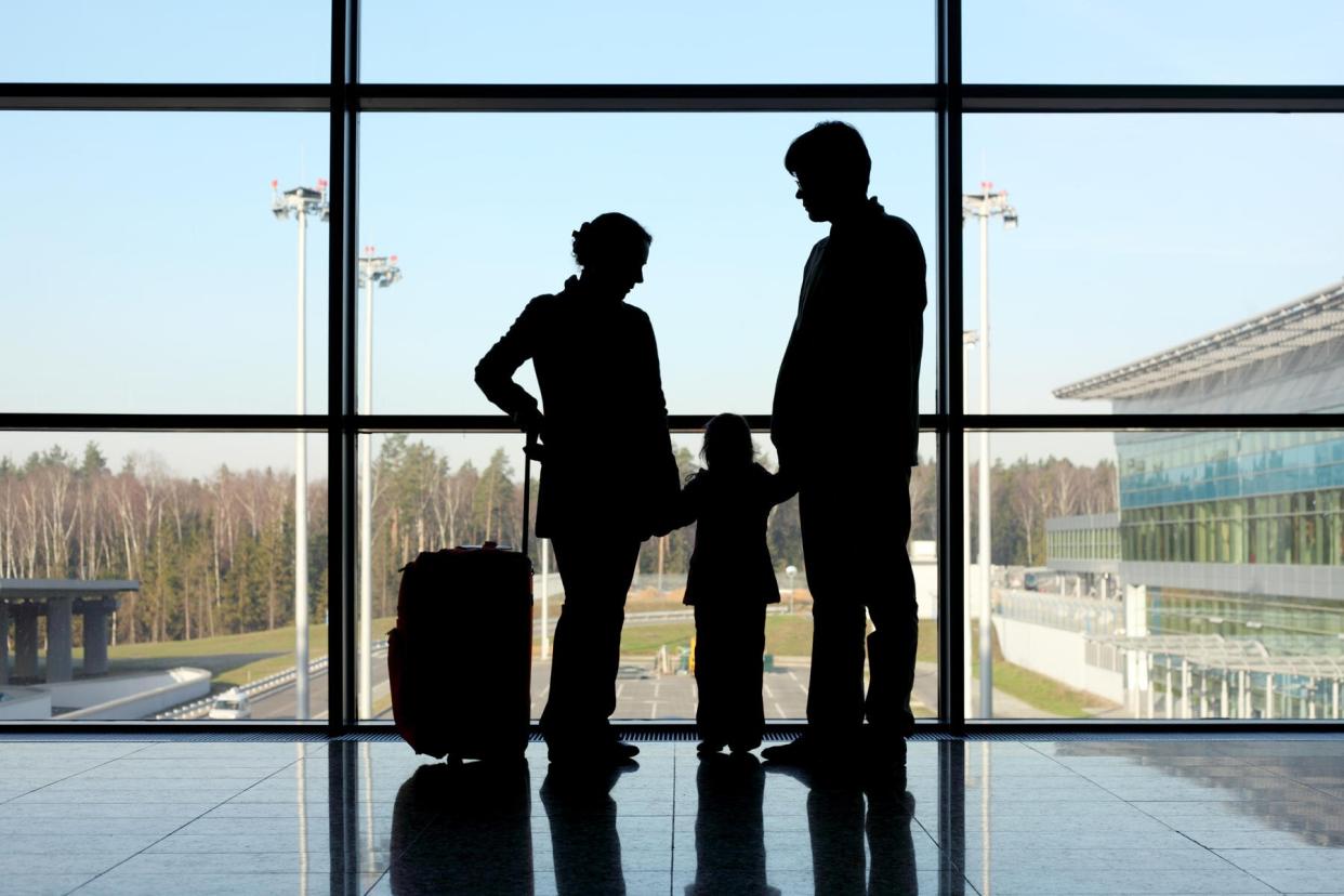 silhouette of family at airport