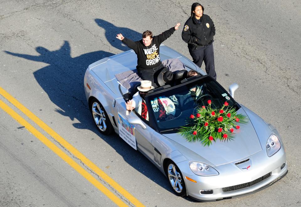 Honorary Grand Marshal and actor David DeSanctis waves.