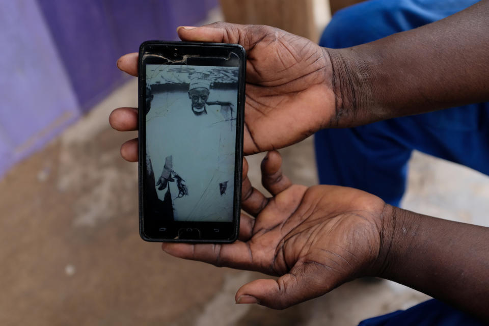 Abdul Sumud Shaibu shows a photograph of his grandfather, in Obuasi, Ghana. "My ancestors were giants," he said. (Photo: Francis Kokoroko/Reuters)