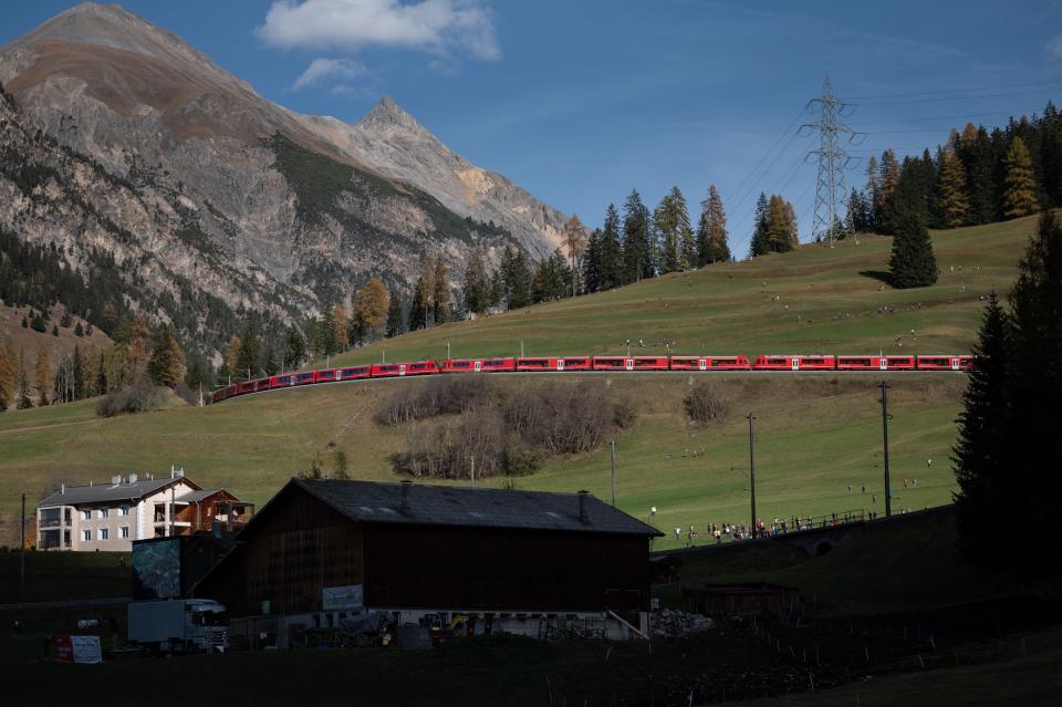 A train with 100 cars passes by in Bergun, Switzerland, on October 29, 2022, during a record attempt by the Rhaetian Railway (RhB) of the world's longest passenger train to mark the Swiss railway operator's 175th anniversary.