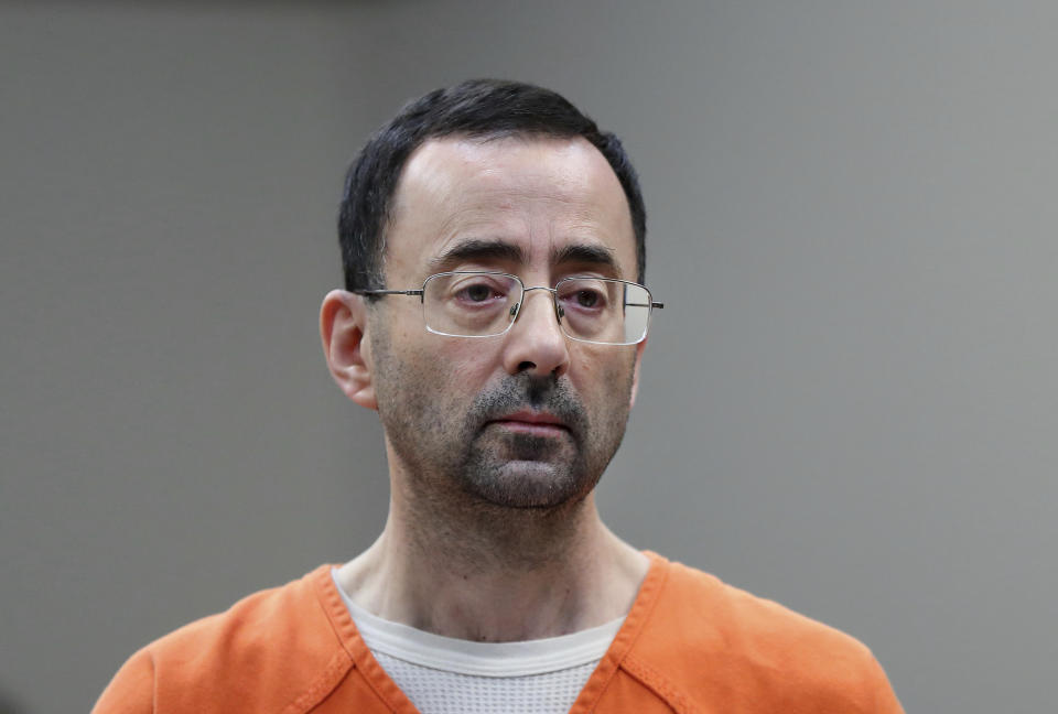 FILE - Dr. Larry Nassar, 54, appears in court for a plea hearing in Lansing, Mich., on Nov. 22, 2017. Recent assaults on two notorious, high-profile federal prisoners have renewed concerns about whether the federal Bureau of Prisons is capable of keeping people in its custody safe. Nassar was knifed repeatedly in his cell at a federal penitentiary in Florida in July. (AP Photo/Paul Sancya, File)