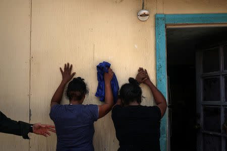 Women from the Dominican Republic are apprehended by the border patrol for illegally crossing into the U.S. border from Mexico in Los Ebanos, Texas, U.S., August 15, 2018. REUTERS/Adrees Latif