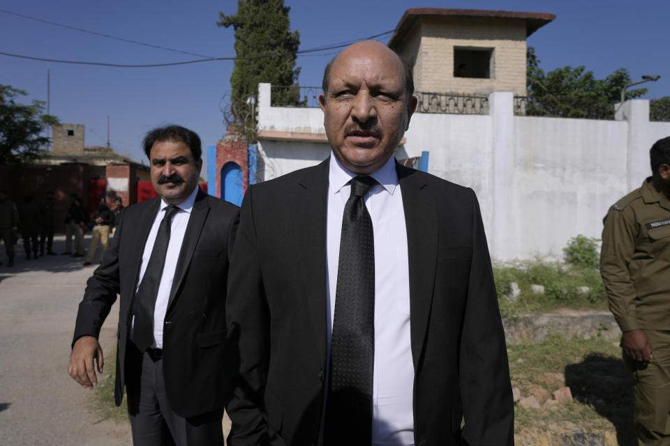 Shah Khawar, center, special prosecutor from Pakistan's Federal Investigation Agency, leaves after hearing of the Cipher case against former Prime Minister Imran Khan, at a special court in Adiyala prison, in Rawalpindi, Pakistan, Monday, Oct. 23, 2023. A Pakistani court indicted Khan on charges of revealing official secrets after his 2022 ouster from office, the strongest indication yet the former prime minister may be unable to run in the upcoming parliamentary elections in late January. (AP Photo/Anjum Naveed)
