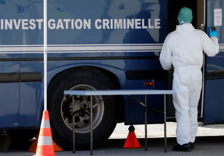 A French investigator enters a Gendarmerie mobile forensic van in Seynes-les-Alpes near the crash site of a Germanwings Airbus A320 in French Alps March 27, 2015. REUTERS/Eric Gaillard