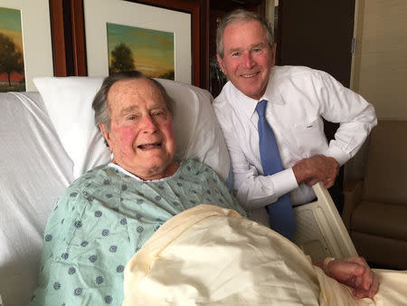 Former president George H.W. Bush (L) is visited in Houston Methodist Hospital by his son George W. Bush as the senior Bush extended his stay in hospital in Houston, Texas, U.S. in this photo released on April 20, 2017. Courtesy Jim McGrath/Handout via REUTERS