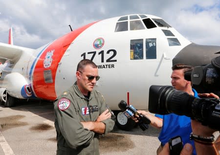 U.S. Coast Guard Lt. Commander Dan DeAngelo speaks with the media after relief supplies were delivered by his C-130 aircraft in Andros