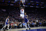 New York Knicks' OG Anunoby (8) goes up for a dunk past Philadelphia 76ers' Kelly Oubre Jr. (9) during the first half of Game 3 in an NBA basketball first-round playoff series, Thursday, April 25, 2024, in Philadelphia. (AP Photo/Matt Slocum)