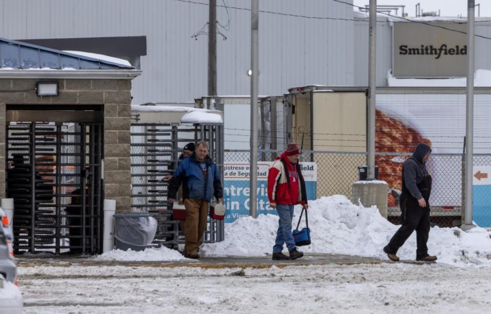 Workers leave after their shift at Smithfield meatpacking plant in Denison, Iowa.