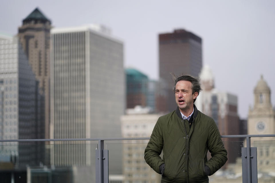 HOLD FOR STORY- Des Moines Downtown Neighborhood Association president Brandon Brown stands on the roof of his condo building, Friday, Nov. 12, 2021, in Des Moines, Iowa. After decades of downplaying or simply ignoring the problem, Des Moines officials here recently began a comprehensive study that will lead to tighter regulations on some smelly manufacturing plants near downtown. (AP Photo/Charlie Neibergall)