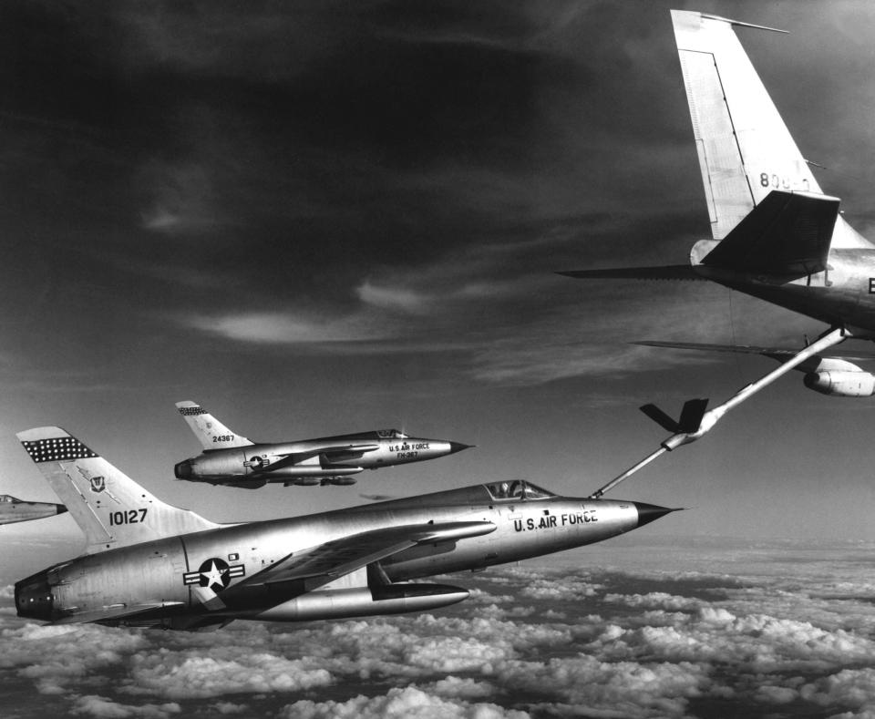 U.S. Air Force F-105 Thunderchief fighter-bombers refuel from a KC-135 Stratotanker, on their way to strike targets in North Vietnam, January 1966. Thunderchiefs were equipped with a flying boom receptacle as well as a retractable refueling probe. <em>Photo by Interim Archives/Getty Images</em>