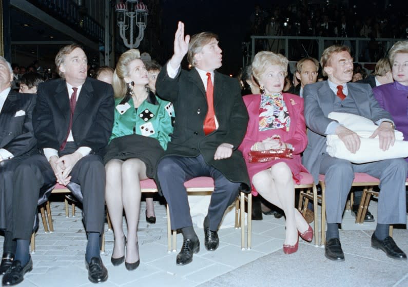 Donald Trump waves to staff members of the Trump Taj Mahal Casino Resort as they cheer him on before the start of the grand opening ceremonies in Atlantic City, N.J., Thursday night on April 5, 1990. Trump attended the gala with his mother, Mary, father, Fred, and sister, the U.S. District Court Judge Maryanne Trump Barry, right. On the left is Donald Trump's brother Robert Trump and his wife Blaine Trump. (AP Photo/Charles Rex Arbogast)