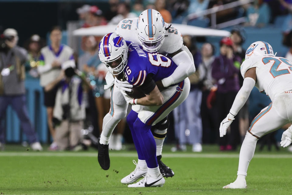 Jan 7, 2024; Miami Gardens, Florida, USA; Buffalo Bills tight end Dalton Kincaid (86) is tackled by Miami Dolphins linebacker Jerome Baker (55) after running with the football during the second quarter at Hard Rock Stadium. Mandatory Credit: Sam Navarro-USA TODAY Sports