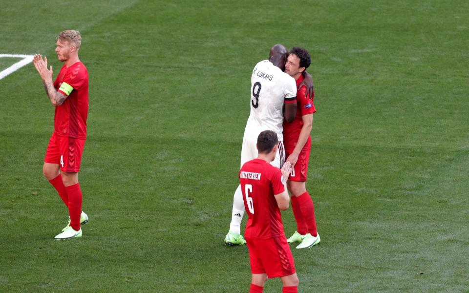 Romelu Lukaku hugs Thomas Delaney after kicking the ball out in the 10th minute of the match to applaud Denmark's Christian Eriksen. - REUTERS