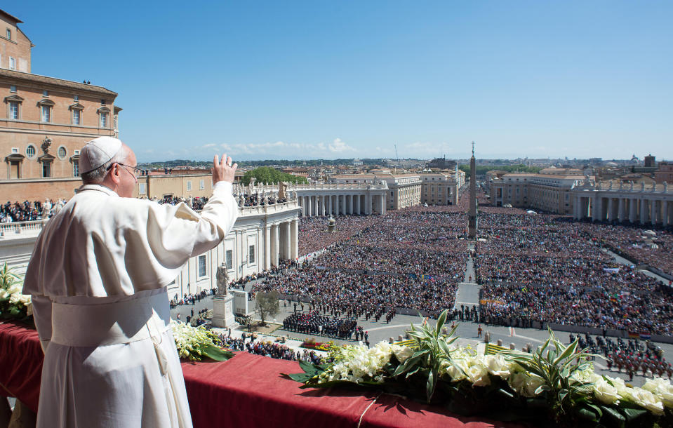 In this photo provided by the Vatican newspaper L'Osservatore Romano, Pope Francis waves to the crowd from the balcony of St. Peter's Basilica where he delivered the Urbi et Orbi (Latin for to the city and to the world) at the end of the Easter Mass in St. Peter's Square at the the Vatican Sunday, April 20, 2014. (AP Photo/L'Osservatore Romano, ho)