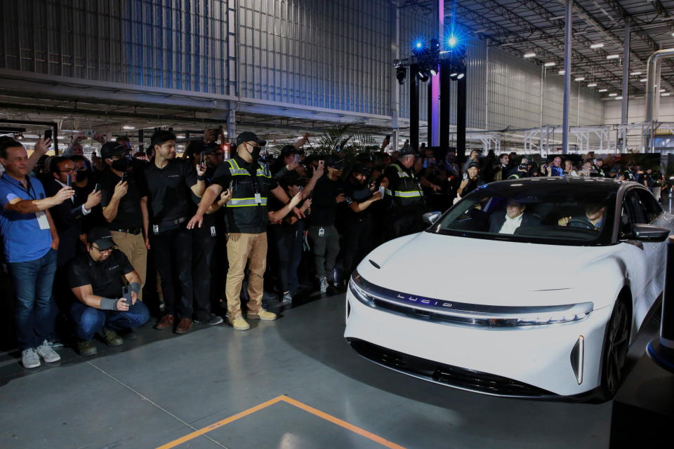 Arizona Governor Doug Ducey rides in the passenger seat as CEO Peter Rawlinson drives a Lucid Air car off the line to cheers at the Lucid Motors plant in Casa Grande, Arizona, U.S. September 28, 2021.  REUTERS/Caitlin O'Hara