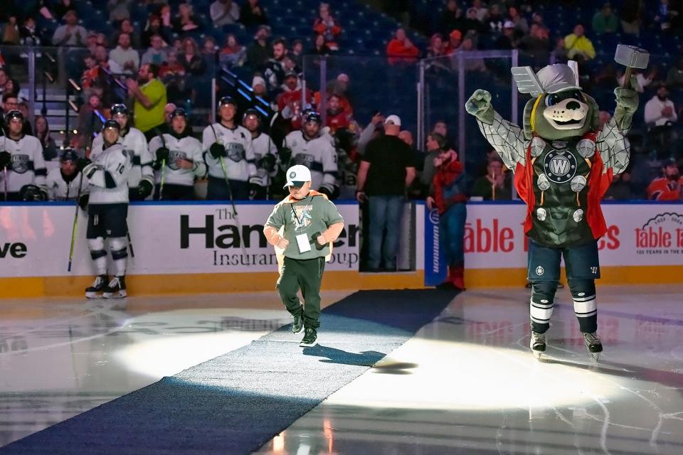 AJ Congdon, an 8-year-old from Oxford, walks out the center ice before dropping the ceremonial first puck prior to the Worcester Railers' game on Nov. 19 at the DCU Center. Congdon recently was diagnosed with an inoperable brain tumor.