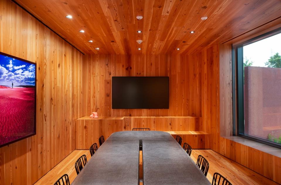 The Jewel Box room, for meetings and special events, is wrapped in pine and decorated with a polished concrete table with chairs, all designed by Adjaye.