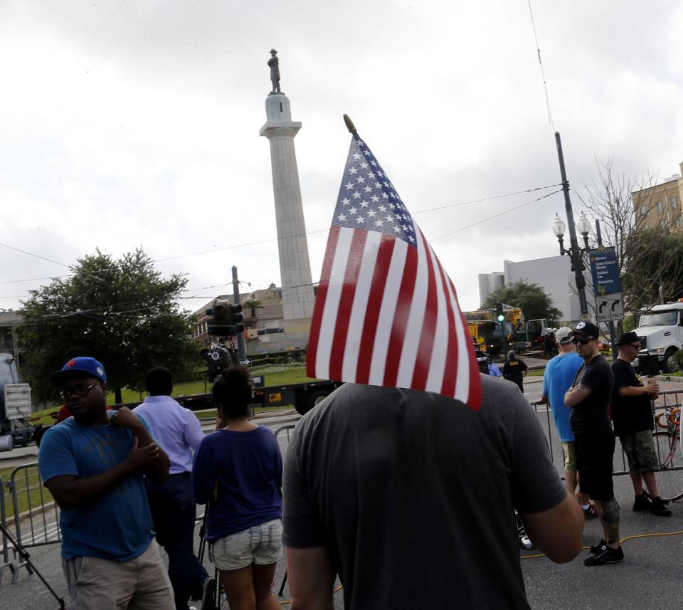 <p>Onlookers stand by as workers prepare to take down a statue of Gen. Robert E. Lee, who commanded Confederate armies fighting the United States in the Civil War, at Lee Circle in New Orleans, Friday, May 19, 2017. (Photo: Gerald Herbert/AP) </p>