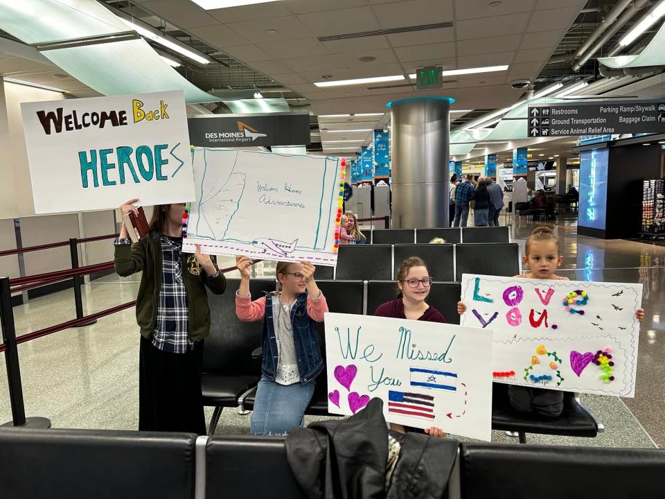 Pastor Glenn Goodwin and members of Urbandale's Gospel Assembly Church were met with signs upon arriving at the Des Moines International Airport. The group spent days trying to get a flight out of Israel after war broke out between the country and Hamas.