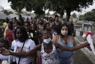 Relatives of Emily Victoria Silva dos Santos, 4, and Rebeca Beatriz Rodrigues dos Santos, 7, mourn during their burial at a cemetery in Duque de Caxias, Rio de Janeiro state, Brazil, Saturday, Dec. 5, 2020. Grieving families held funerals for Emily and Rebeca, killed by bullets while playing outside their homes. Weeping and cries of “justice” were heard Saturday at their funerals, reflecting the families’ assertion that the children were killed by police bullets. (AP Photo/Silvia Izquierdo)