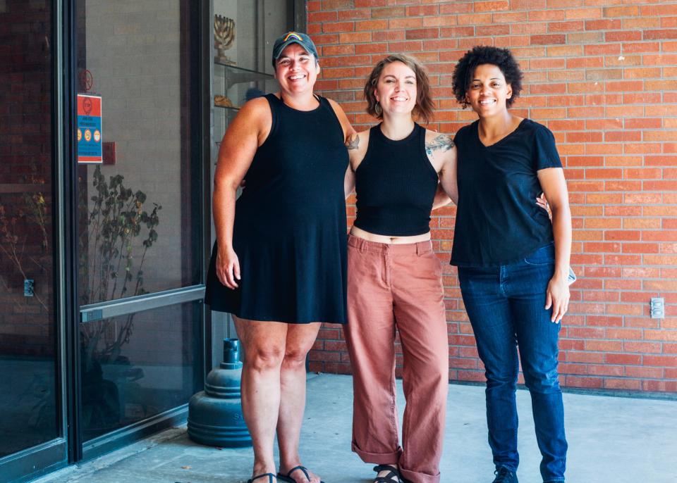 Audra Sergel, Violet Vonder Haar and Phylshawn Johnson pose for a photo shortly after signing a lease to convert part of the University of Missouri Hillel building into Compass Music Center.