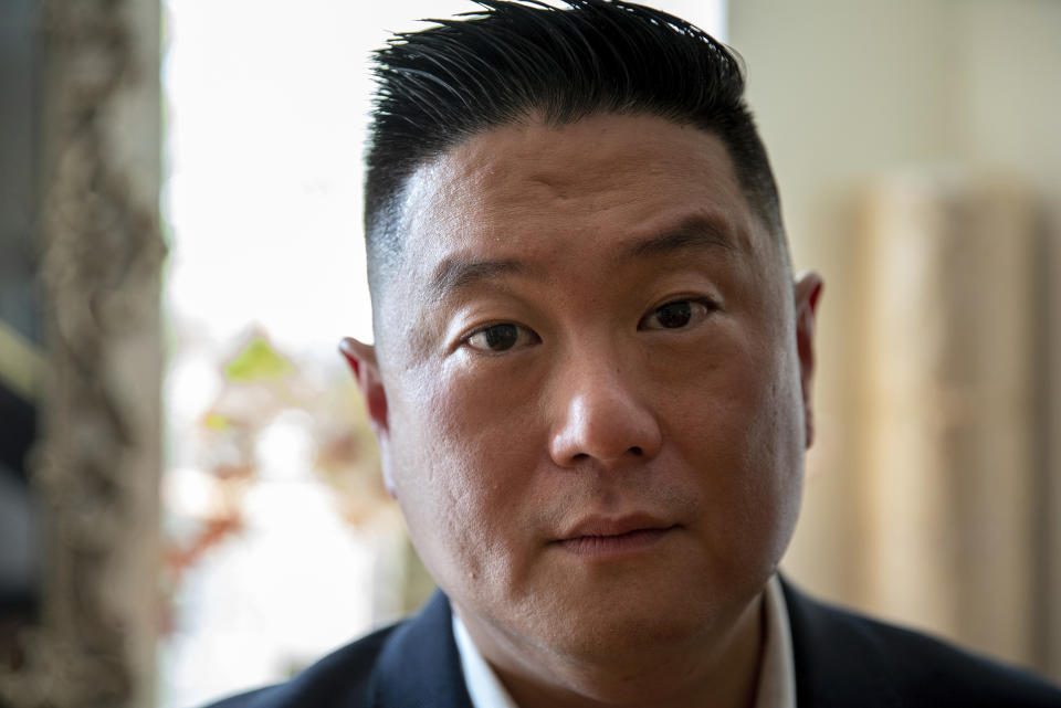 Charlton Rhee poses for a photo in the Queens borough of New York, Aug. 18, 2020. Rhee, whose parents came to the U.S. from South Korea, lost both of them to COVID-19 this spring as the virus surged in New York City. A joint analysis by The Associated Press and The Marshall Project found that Asian Americans join Black and Hispanic Americans among the hardest-hit groups, with deaths in each group up at least 30% this year. (AP Photo/Marshall Ritzel)