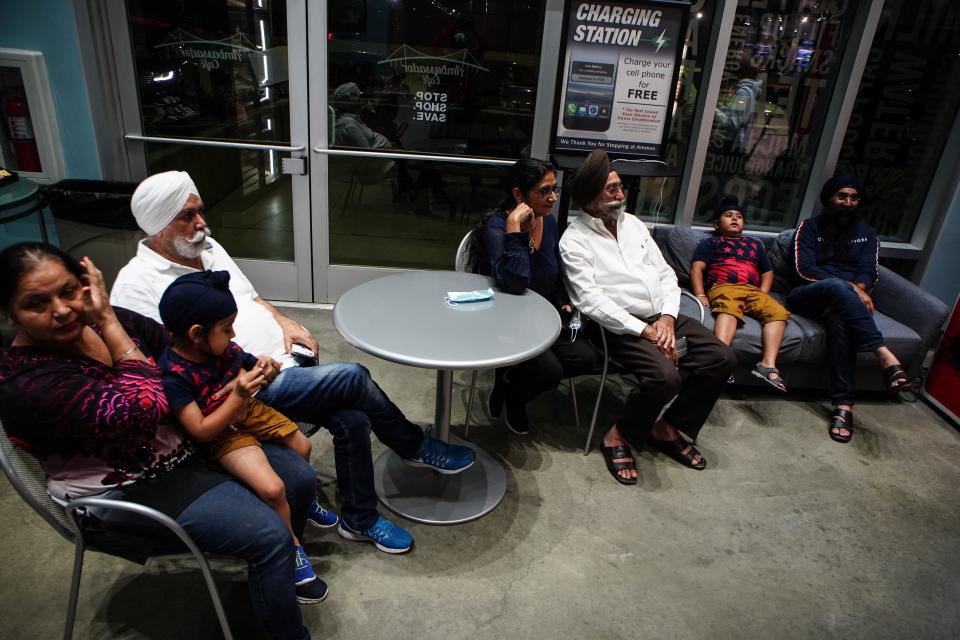 The Singh and Kaur family stop at the Ambassador Duty Free store, waiting for the clock to hit midnight in Detroit on Sunday, August 8, 2021. Canada reopened its borders to the United States on Monday, allowing for fully vaccinated U.S. citizens and permanent residents to cross the border.