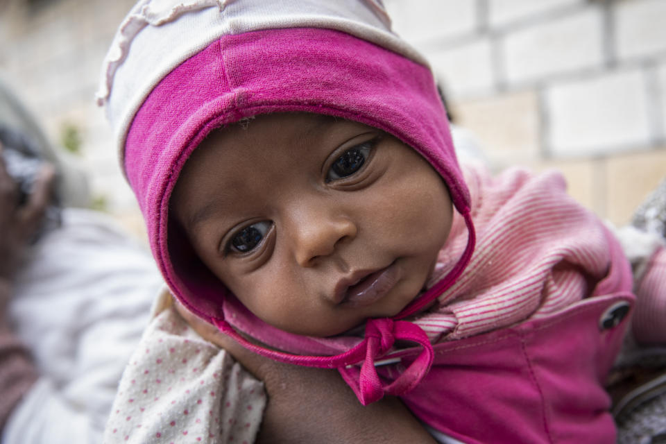 Mother Senait holds her two month old baby Angesom, who was born in the classroom of a primary school after her mother fled from Shire, in Adigrat town, in the Tigray region of northern Ethiopia Monday, Feb. 22, 2021. (Zerihun Sewunet/UNICEF via AP)