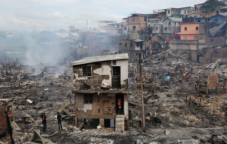 Residents are seen after a fire at Educandos neighbourhood, on a branch of the Rio Negro, a tributary to the Amazon river, in the city of Manaus, Brazil December 18, 2018. REUTERS/Bruno Kelly