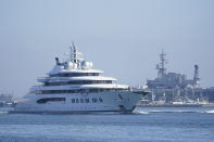 The super yacht Amadea passes the USS Midway Museum as it comes into the San Diego Bay Monday, June 27, 2022, seen from Coronado, Calif. The $325 million superyacht seized by the United States from a sanctioned Russian oligarch arrived in San Diego Bay on Monday. (AP Photo/Gregory Bull)