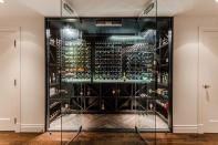 <p>The basement has a home theatre, workshop, maid’s quarters, and this contemporary wine cellar. (Listing via <span>Sotheby’s</span>) </p>