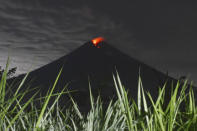 Mount Semeru releases volcanic materials during an eruption as seen from Lumajang district, East Java province, Indonesia, Tuesday, Dec. 7, 2021. The highest volcano on Java island spewed thick columns of ash into the sky in a sudden eruption Saturday triggered by heavy rains. Villages and nearby towns were blanketed by tons of volcanic debris. (AP Photo/Hendra Permana)