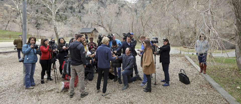 Democratic presidential candidate Sen. Elizabeth Warren, D-Mass., center, speaks with the media during an visit to Big Cottonwood Canyon Wednesday, April 17, 2019, east of Salt Lake City. Warren is in Utah Wednesday after promising to restore broader public lands protections for two of the state's high-profile national monuments if elected president. It's a move that would not endear her to Utah's GOP establishment but could appeal to voters across the West angered by President Donald Trump's decision to shrink the monuments. (AP Photo/Rick Bowmer)