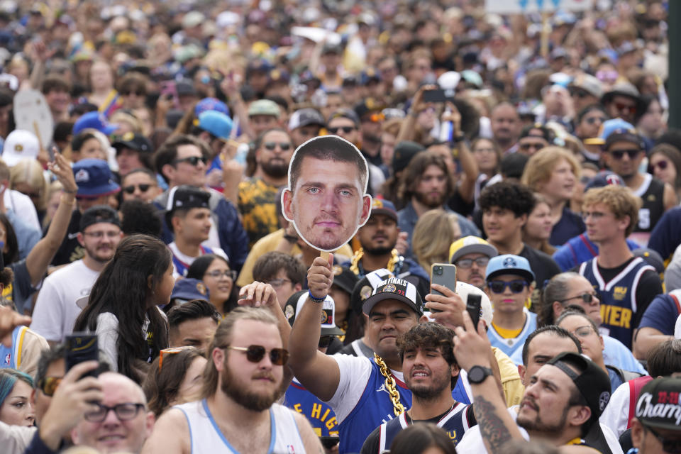 A fan holds up a cutout of Denver Nuggets center Nikola Jokic during a rally and parade to mark the Denver Nuggets first NBA basketball championship on Thursday, June 15, 2023, in Denver. (AP Photo/David Zalubowski)