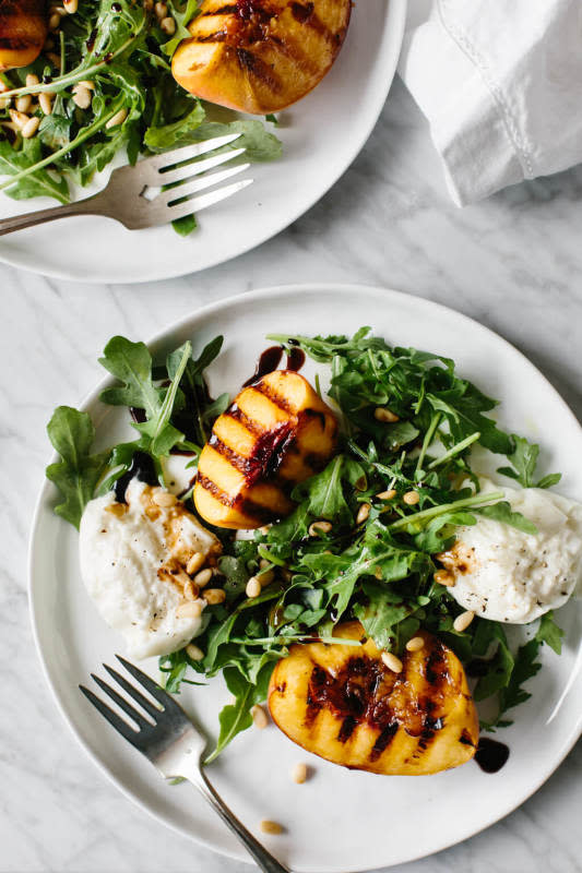 <p>Downshiftology</p><p>Grilled peach and burrata salad is summertime on a plate. The mix of grilled peaches, creamy burrata, arugula, pine nuts and balsamic is perfection.</p><p><strong>Get the recipe: <a href="https://downshiftology.com/recipes/grilled-peach-burrata-salad/" rel="nofollow noopener" target="_blank" data-ylk="slk:Grilled Peach and Burrata Salad;elm:context_link;itc:0;sec:content-canvas" class="link rapid-noclick-resp"><em>Grilled Peach and Burrata Salad</em></a></strong></p>