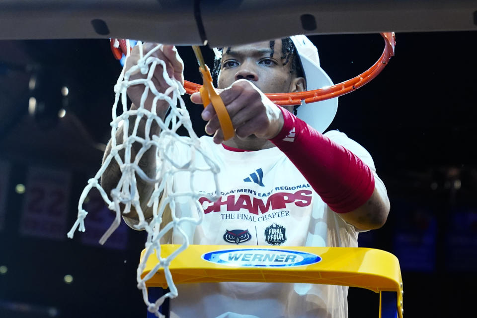 Florida Atlantic's Alijah Martin (15) cuts the net after Florida Atlantic defeated Kansas State in an Elite 8 college basketball game in the NCAA Tournament's East Region final, Saturday, March 25, 2023, in New York. (AP Photo/Frank Franklin II)