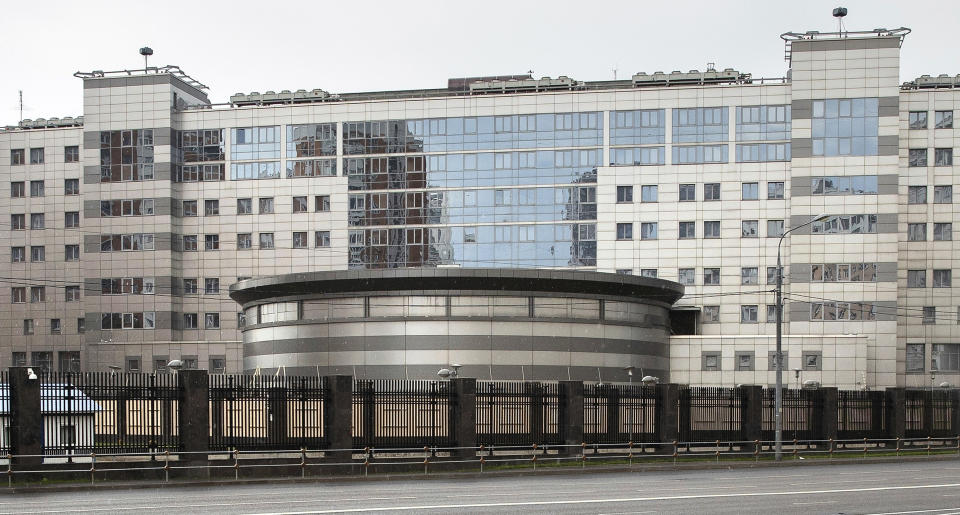 FILE - In this Saturday, July 14, 2018 file photo, a man walks past the building of the Main Directorate of the General Staff of the Armed Forces of Russia, also know as Russian military intelligence service in Moscow, Russia. The U.S. Justice Department has charged seven Russian military intelligence officers with hacking anti-doping agencies and other organizations hours after British and Dutch officials leveled new accusations against the military unit. An indictment announced in Washington on Thursday, Oct. 4 says Russia's military intelligence agency, known as the GRU, targeted the hacking victims because they had publicly supported a ban on Russian athletes in international sports competitions and because they had condemned Russia's state-sponsored athlete doping program. (AP Photo/Pavel Golovkin, File)