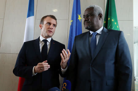 French President Emmanuel Macron talks to African Union Commission Chairperson Moussa Faki Mahamat before addressing a news conference after the meeting at the African Union headquarters in Addis Ababa, Ethiopia March 13, 2019. REUTERS/Tiksa Negeri