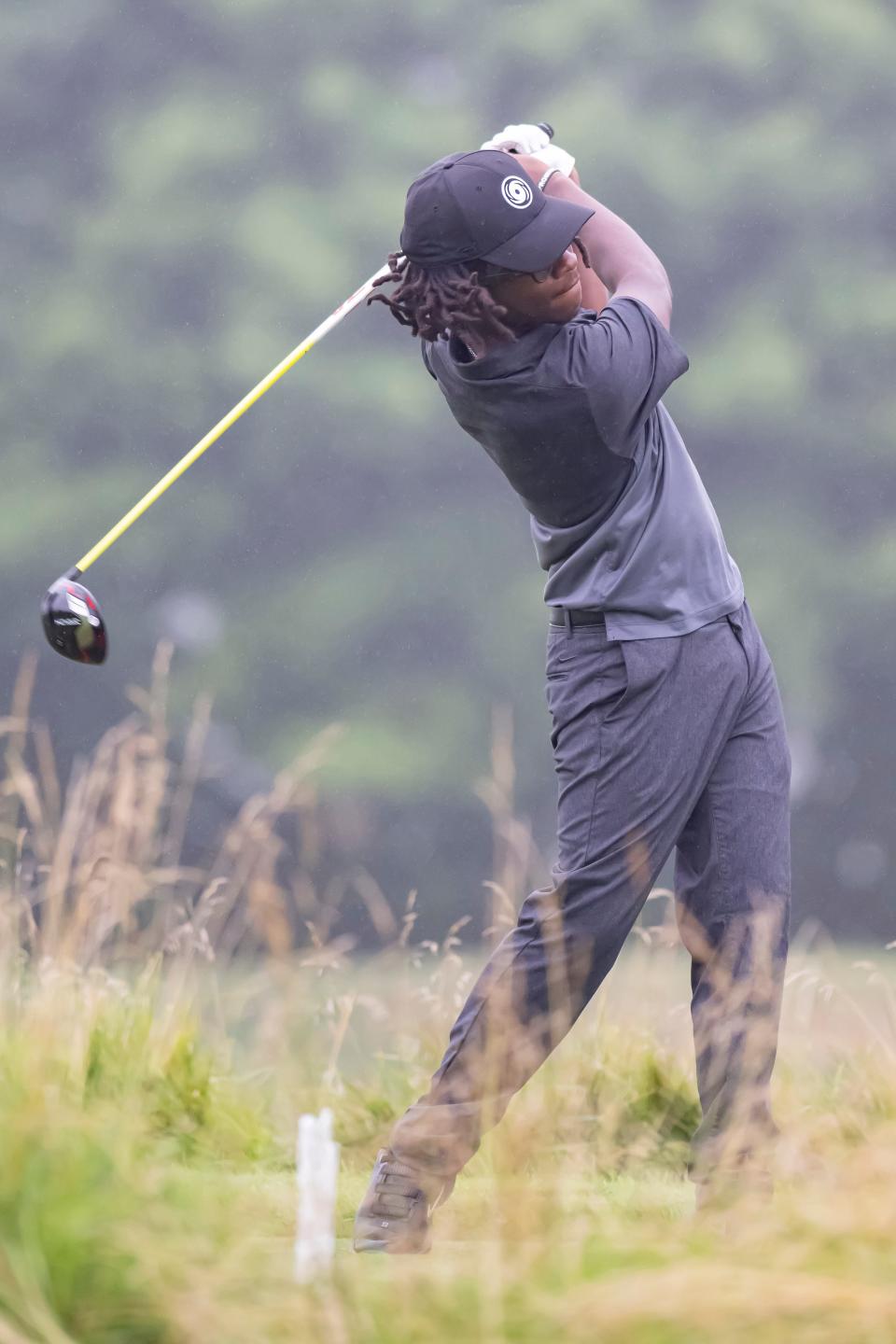 Ajani Johnson smashes a drive sending his tee flying at the Men's City Golf Tournament, presented by the Bob Rohrman Auto Group, Sunday Jul. 17, 2022 in West Lafayette.