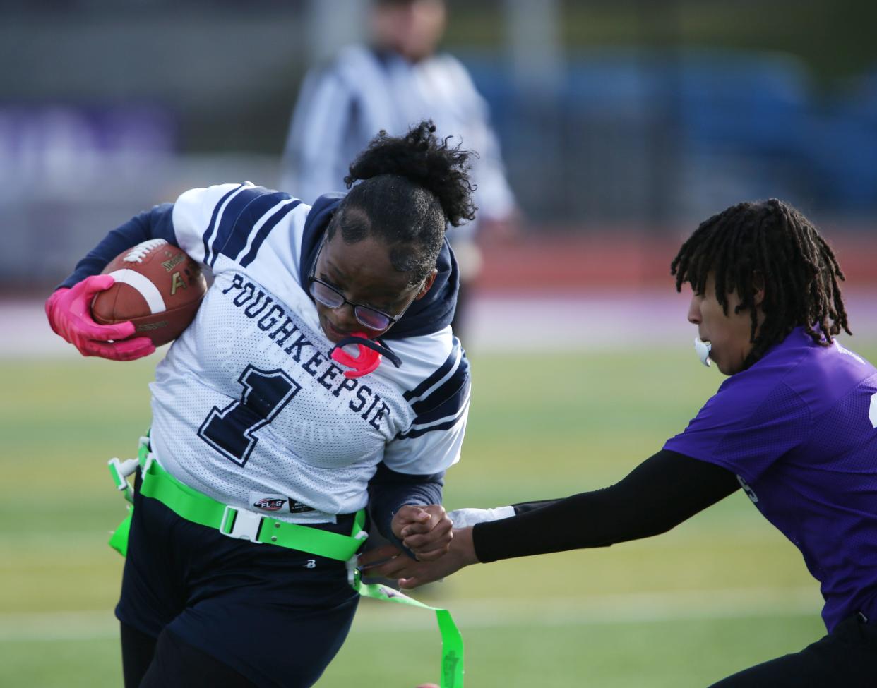 Poughkeepsie's Allysha Anderson carries the ball away from a Monroe-Woodbury's defender during a game on April 4, 2024.