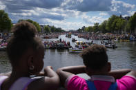 Hundreds of thousands of people lined canals in the Dutch capital to watch the colorful spectacle of the Pride Canal Parade return for the 25th edition after the last two events were canceled due to the COVID-19 pandemic, in Amsterdam, Netherlands, Saturday, Aug. 6, 2022. (AP Photo/Peter Dejong)