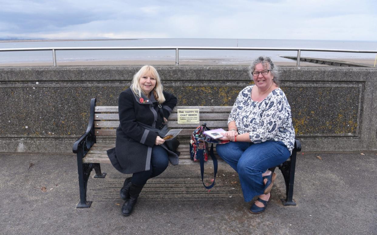 Ann Davies (left) and Helen Brodie MBE use the 'chatty bench' to strike up conversations with strangers - COPYRIGHT JAY WILLIAMS