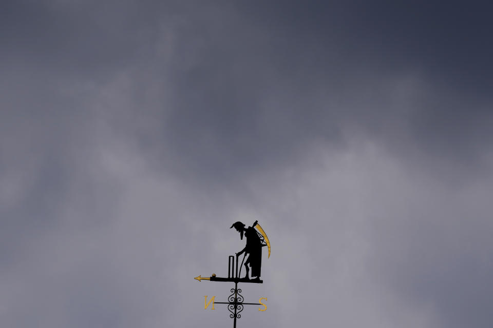 FILE - Dark clouds over the Father Time weathervane during the first day of the test match between England and South Africa at Lord's cricket ground in London, Wednesday, Aug. 17, 2022. An independent commission has found that institutional racism, sexism and class-based discrimination continue to infect English cricket. A long-awaited report into the state of the sport was published by the Independent Commission for Equity in Cricket (ICEC). It found that reform was needed to "tackle discrimination, remove barriers and reform the game to make cricket more inclusive." (AP Photo/Kirsty Wigglesworth, File)