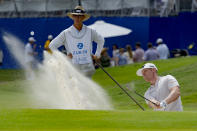 Patrick Fishburn, right, hits from a bunker on the 18th hole during the third round of the PGA Zurich Classic golf tournament at TPC Louisiana in Avondale, La., Saturday, April 27, 2024. (AP Photo/Matthew Hinton)