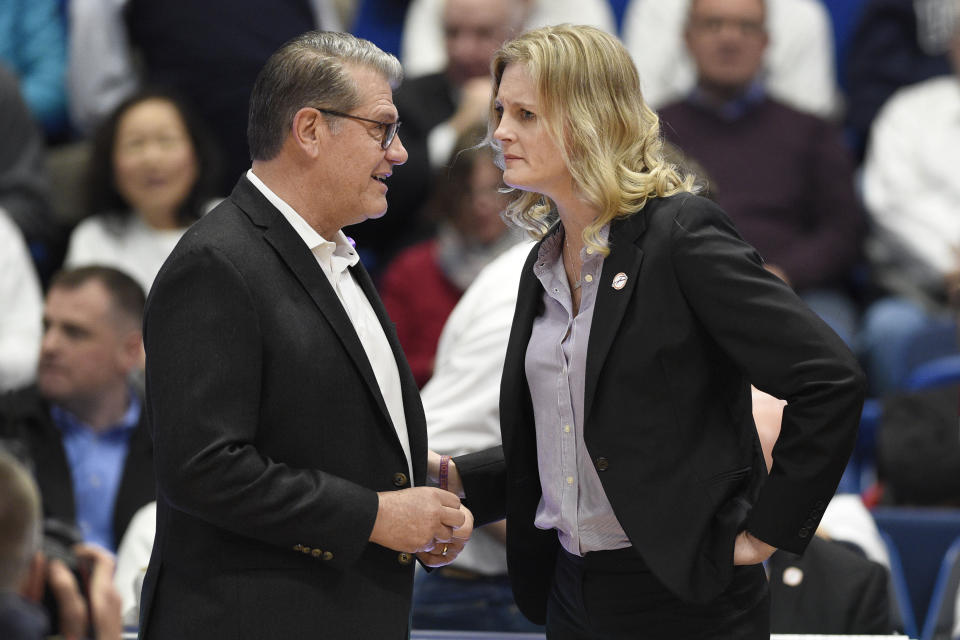 Connecticut head coach Geno Auriemma, left, talks with Tennessee head coach Kellie Harper before of an NCAA college basketball game, Thursday, Jan. 23, 2020, in Hartford, Conn. (AP Photo/Jessica Hill)